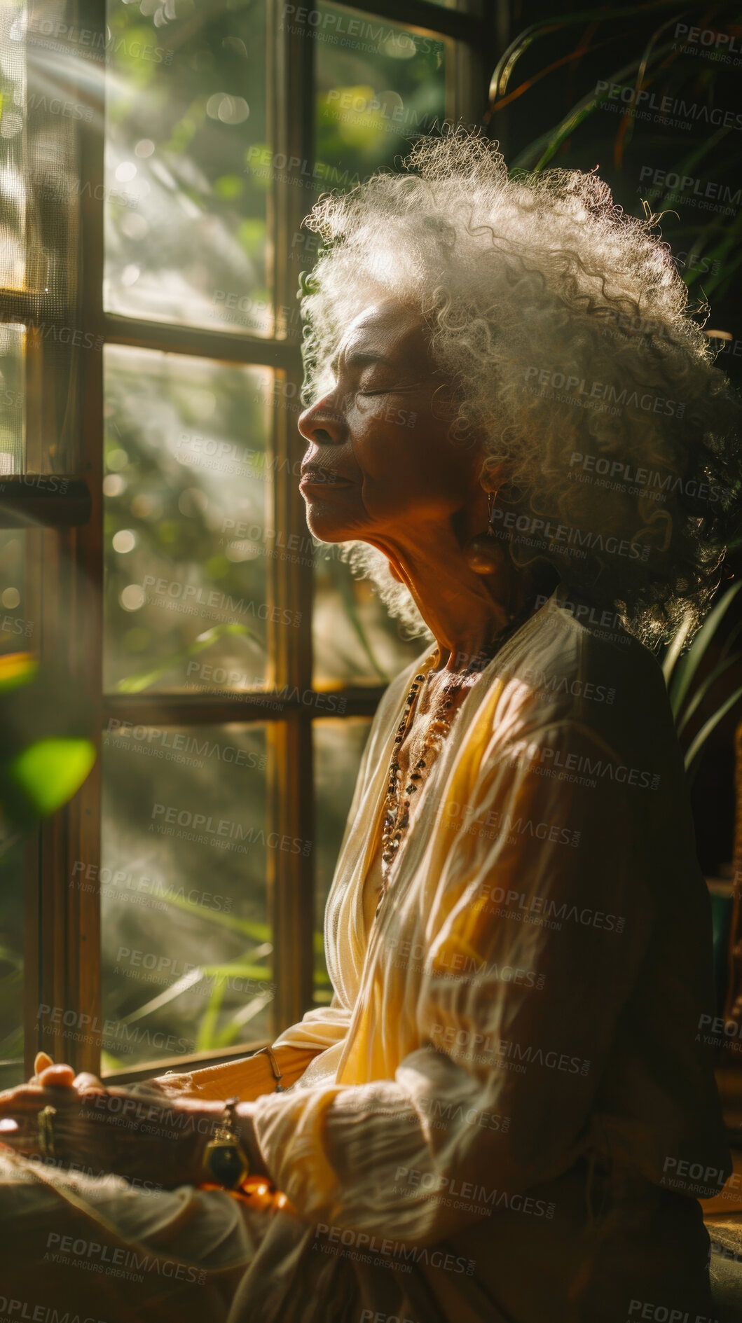 Buy stock photo Meditate, elderly African and woman with plants. Senior, retirement and spiritual health in room with large window. Thinking, thoughtful and praying in sunset for worship and lifestyle concept