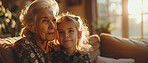 Girl, grandma and sofa for love in bonding time together in home in school holiday. Grandmother, kid and living room care, relationship and time as family connecting on couch in living room