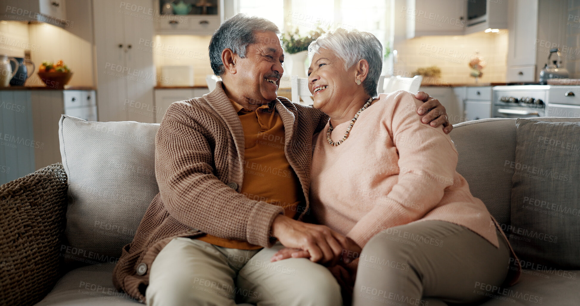 Buy stock photo Senior couple, face and hug on couch, smile and bonding with love, support and relax in retirement in home. Elderly woman, old man and portrait with embrace, together and sitting on living room sofa