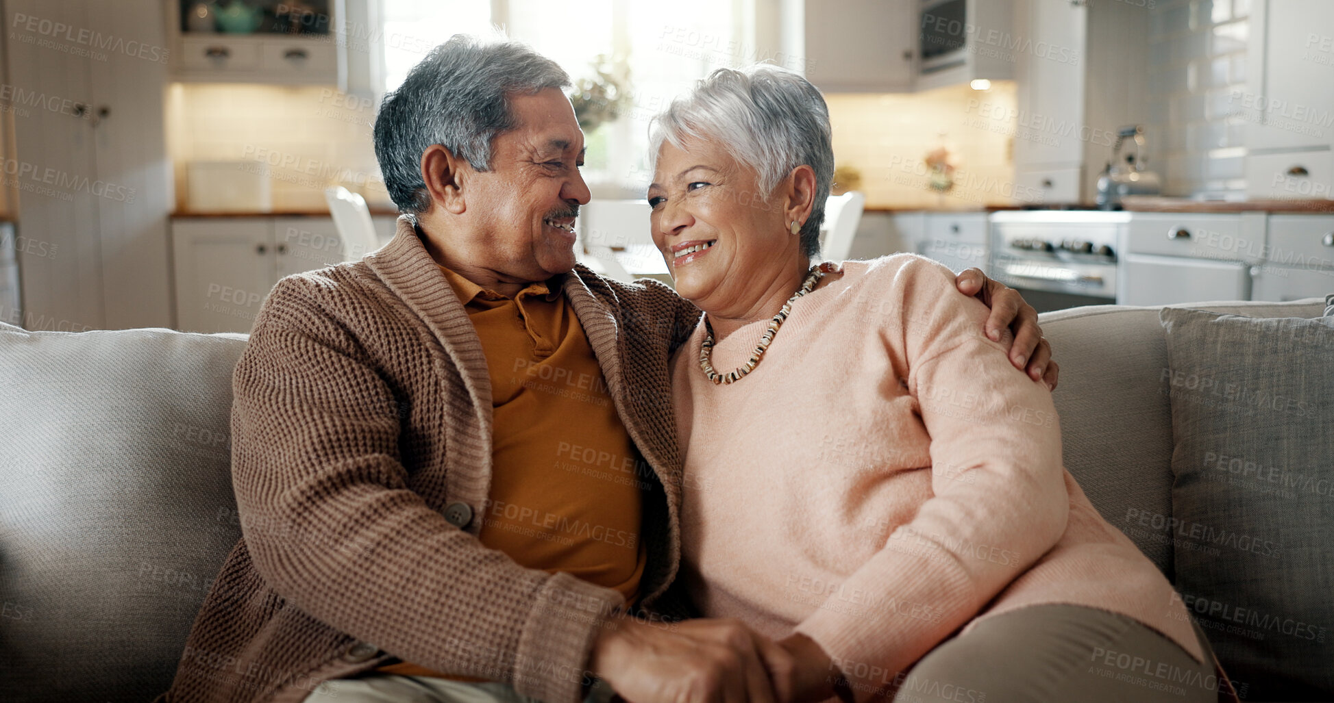 Buy stock photo Senior couple, face and hug on couch, smile and bonding with love, support and relax in retirement in home. Elderly woman, old man and portrait with embrace, together and sitting on living room sofa