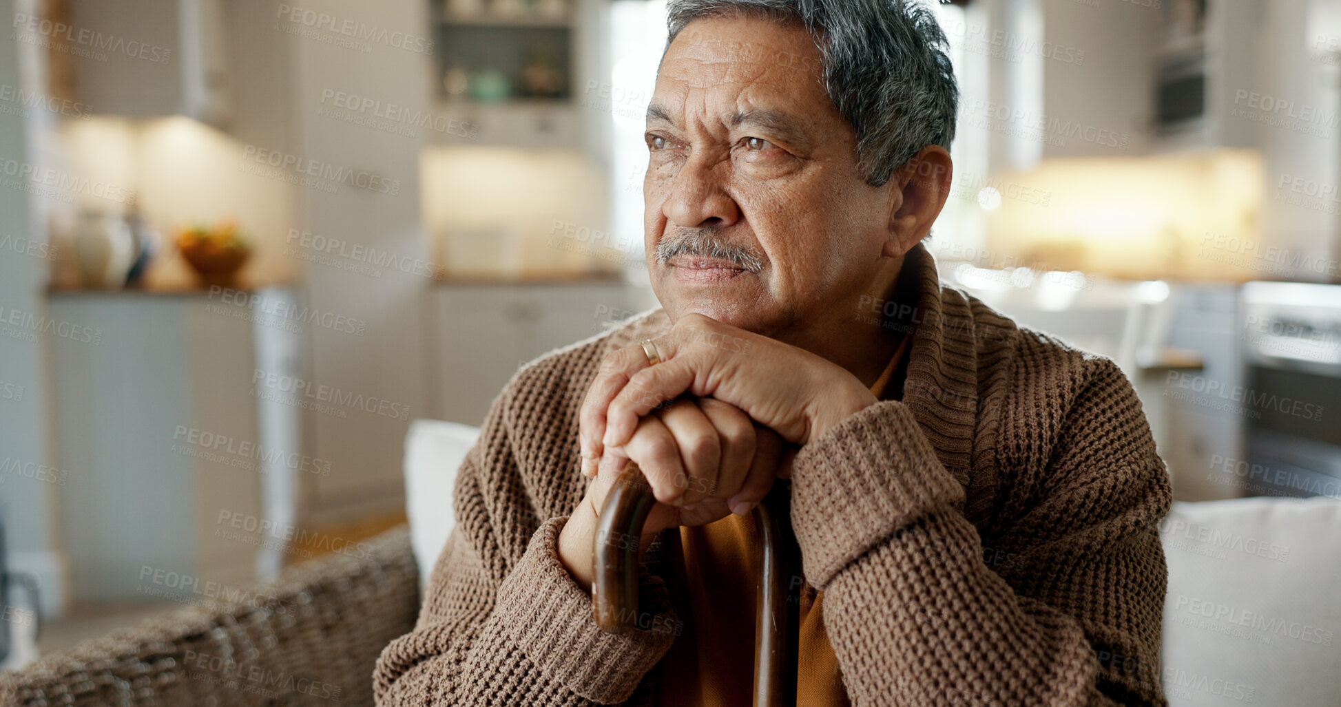 Buy stock photo Depression, nostalgia and a senior man with a cane on a sofa in the living room of his retirement home alone. Memory, thinking and an elderly person with a walking stick in a house feeling sad