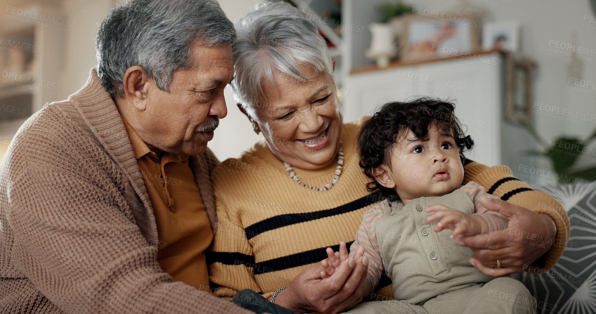 Buy stock photo Grandparents, grandchild and home with baby, babysitting and spending quality time while bonding together, love and trust. Happy family, support and smiling on couch, retired and caring for child.