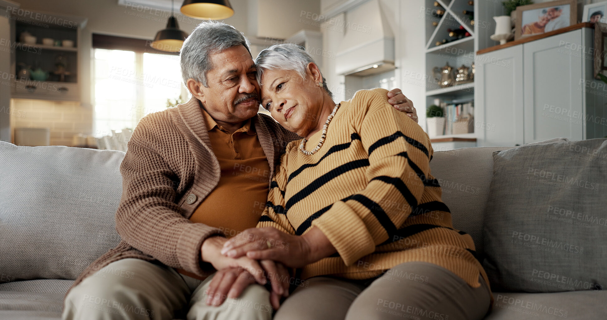 Buy stock photo Senior, couple and hug for empathy on sofa with support, grief and comfort in living room of house. Old people, man and woman with love and embrace for security, compassion and sympathy on couch