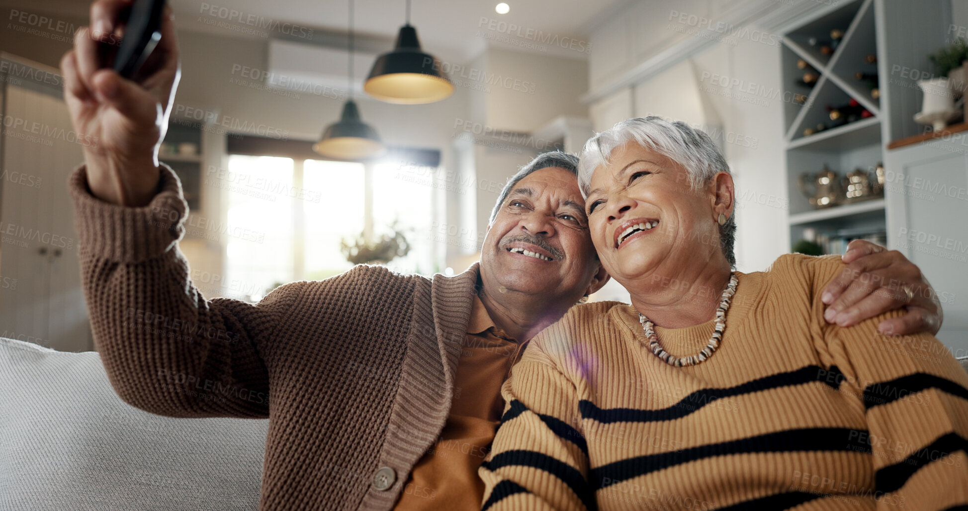 Buy stock photo Senior couple, selfie and smile on sofa, hug and bonding with love, support and relax in retirement in home. Elderly woman, old man and happy with profile profile, web blog and social media on couch