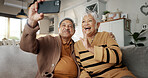 Senior couple, selfie and smile on sofa, hug and bonding with love, support and relax in retirement in home. Elderly woman, old man and happy with profile profile, web blog and social media on couch