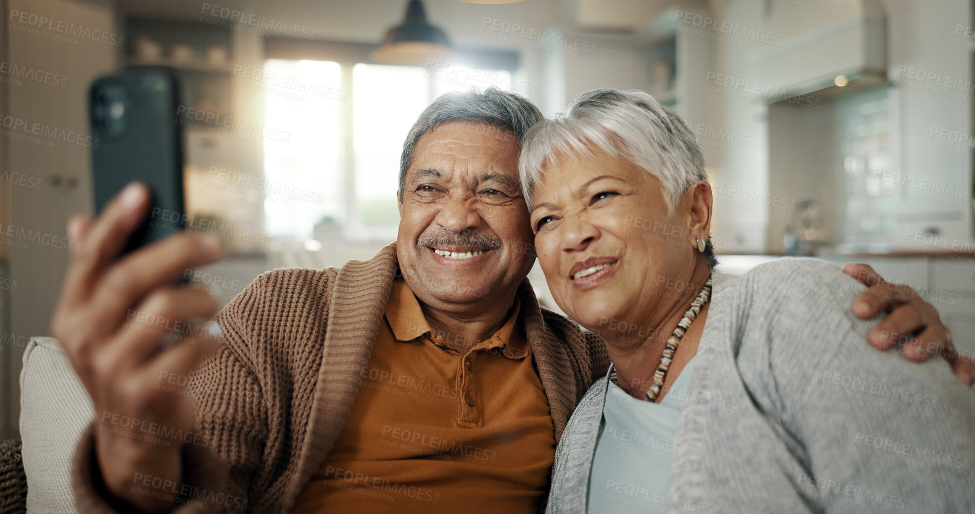 Buy stock photo Senior couple, video call and wave on sofa, smile and hug with love, phone and relax in retirement in home. Elderly woman, old man and webinar with chat, together and talking on living room couch