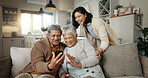 Video call, living room and woman with senior parents on a sofa relaxing and talking on a phone. Smile, bonding and female person with elderly people on virtual conversation with cellphone at home.