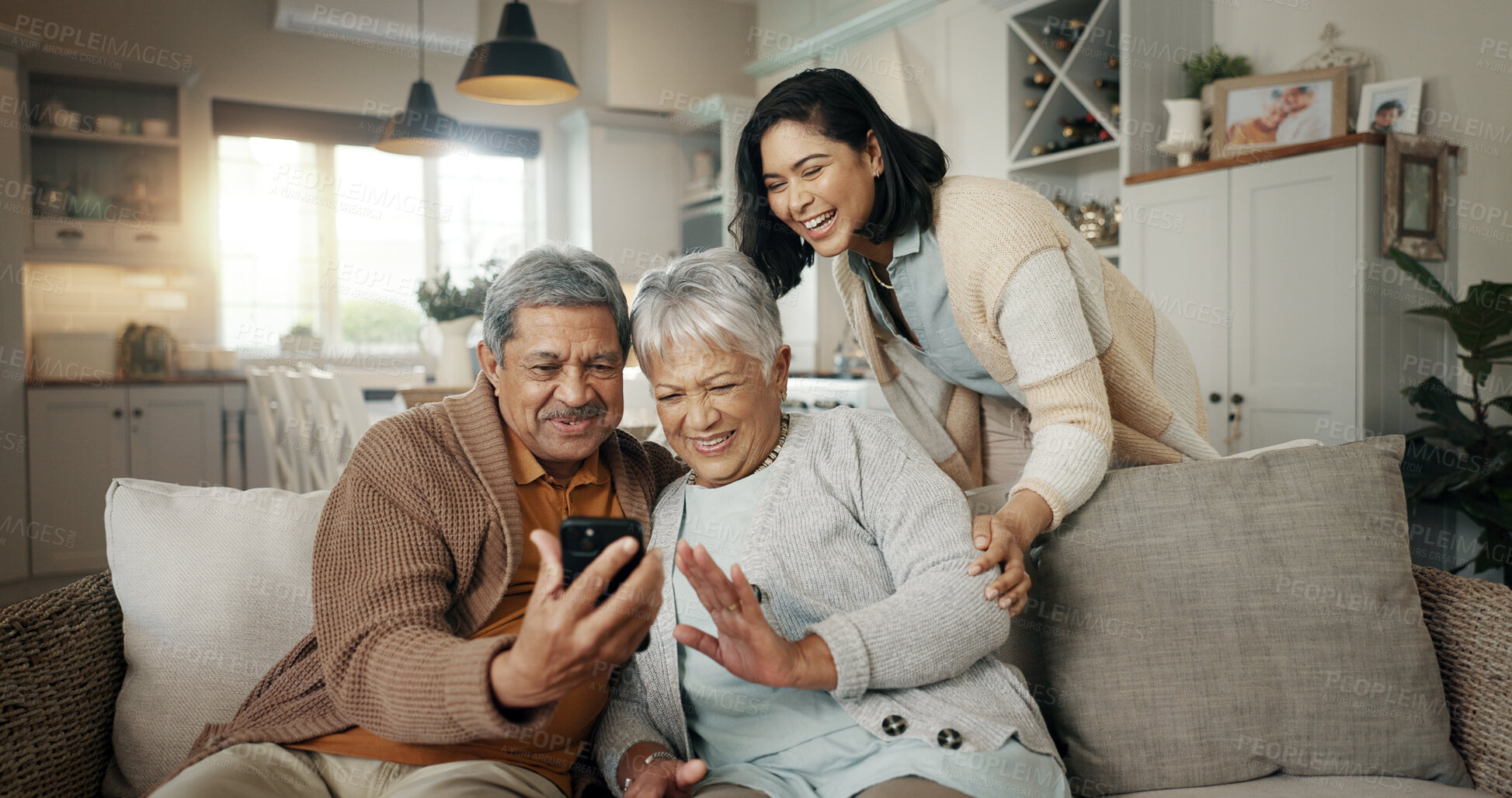 Buy stock photo Video call, living room and woman with senior parents on a sofa relaxing and talking on a phone. Smile, bonding and female person with elderly people on virtual conversation with cellphone at home.