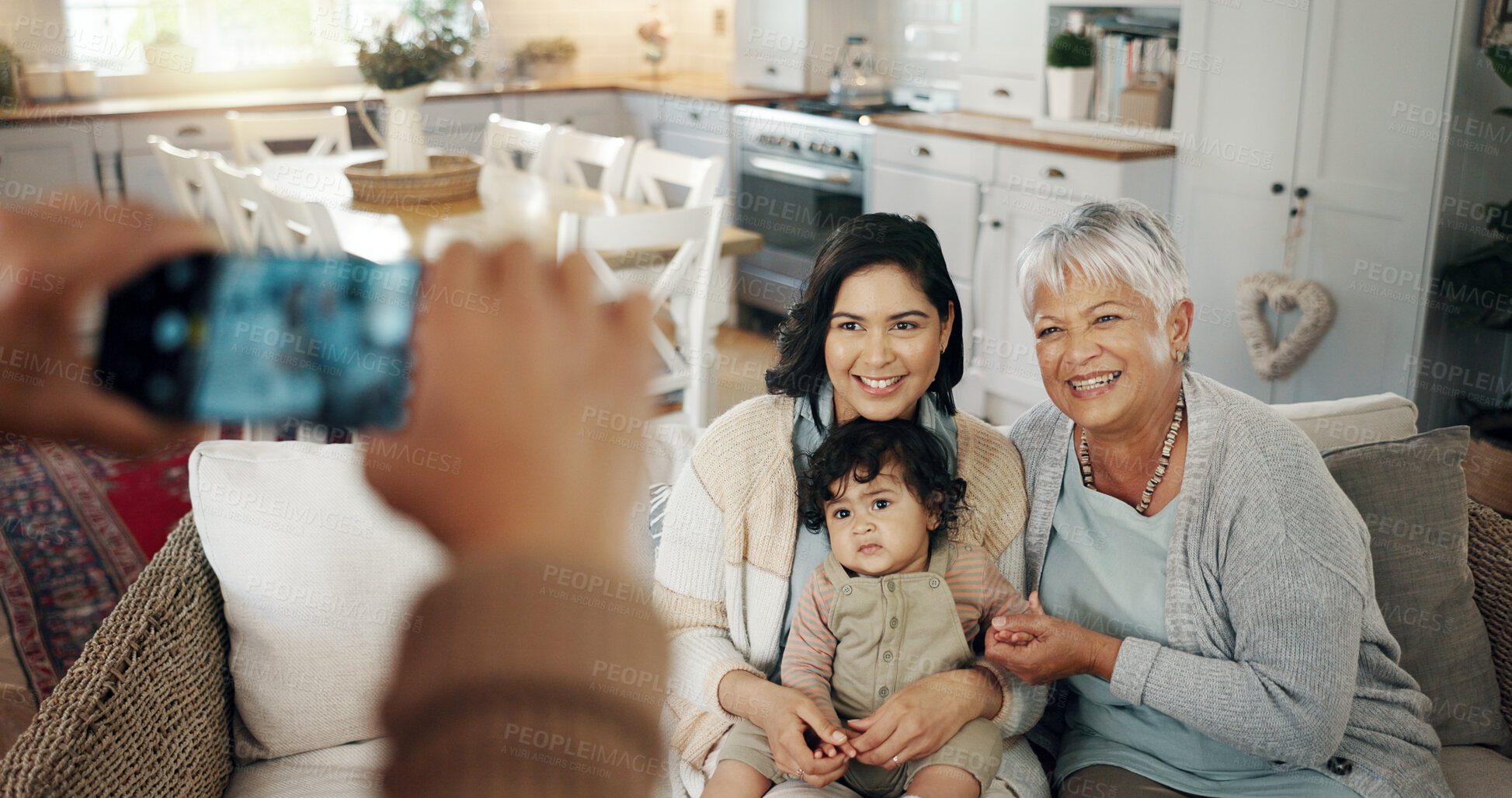 Buy stock photo Phone screen, hands and picture of family in living room with smile, kids and grandparent on sofa. Social media, photo and mother with a baby and grandmother happy in a home together with love