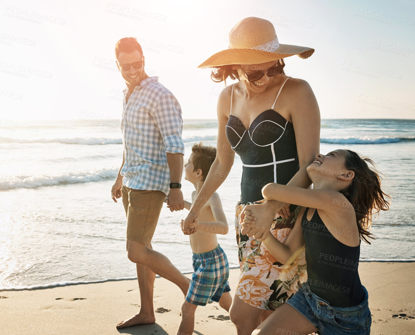 Buy stock photo Beach, family walking and holding hands on vacation, support and laughing on coast of Italy. Parents, children and happiness together on holiday at sea, ocean and bonding on travel adventure to play