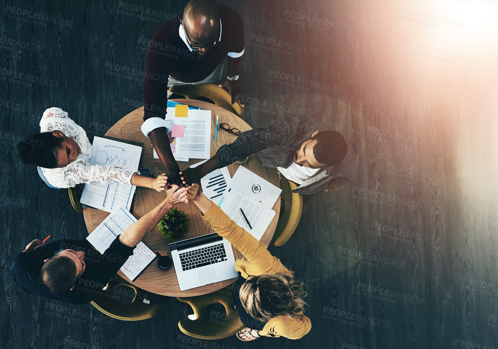 Buy stock photo Above, office and people with pile of hands in meeting for teamwork, collaboration and brainstorming. Business, employees and strategy with laptop or paperwork and unity with statistics or report