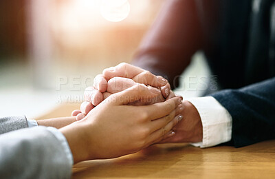 Buy stock photo Business people, hands together and support with comfort for care, grief or trust on office desk. Closeup of employees or colleagues touching with empathy for hope, loss or understanding at workplace