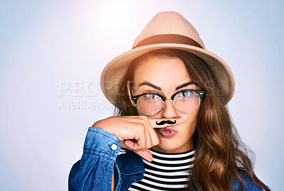 Buy stock photo Portrait, woman and fashion with moustache in studio for funny, comic and funky aesthetic of dress up party. Silly, female person and trendy hat, brand eyewear and pout for event on white background