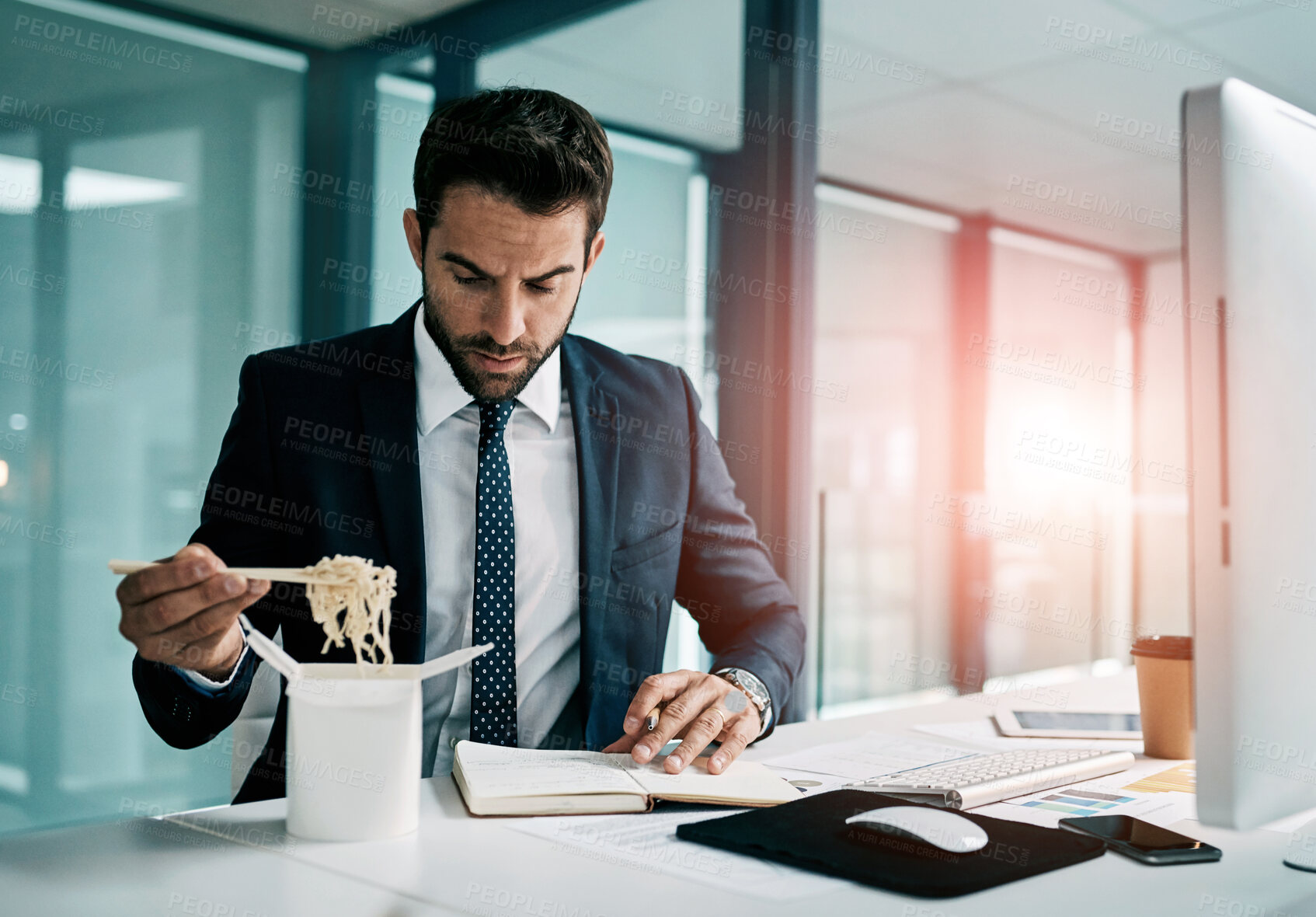 Buy stock photo Fast food, office and business man on computer for planning, working and productivity with lunch. Corporate worker or accountant multitasking and eating ramen, noodles or Chinese takeout for deadline