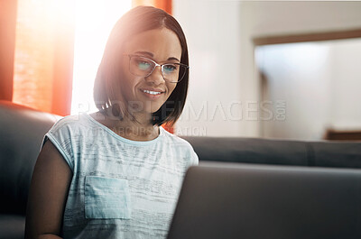 Buy stock photo Woman, laptop and happy on couch for remote work, blog and online for notification or email. Freelance writer, technology and smile for reading ebook on internet for website or social media in home