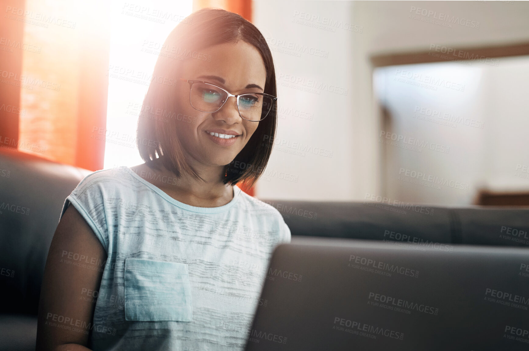 Buy stock photo Woman, laptop and happy on couch for remote work, blog and online for notification or email. Freelance writer, technology and smile for reading ebook on internet for website or social media in home