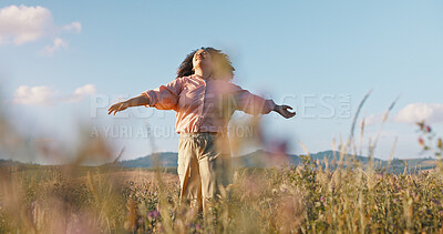 Woman, freedom and dancing in field of flowers, countryside and peace in sustainable environment. Female person, holiday and adventure in nature or outdoors, calm and zen or wellness on vacation