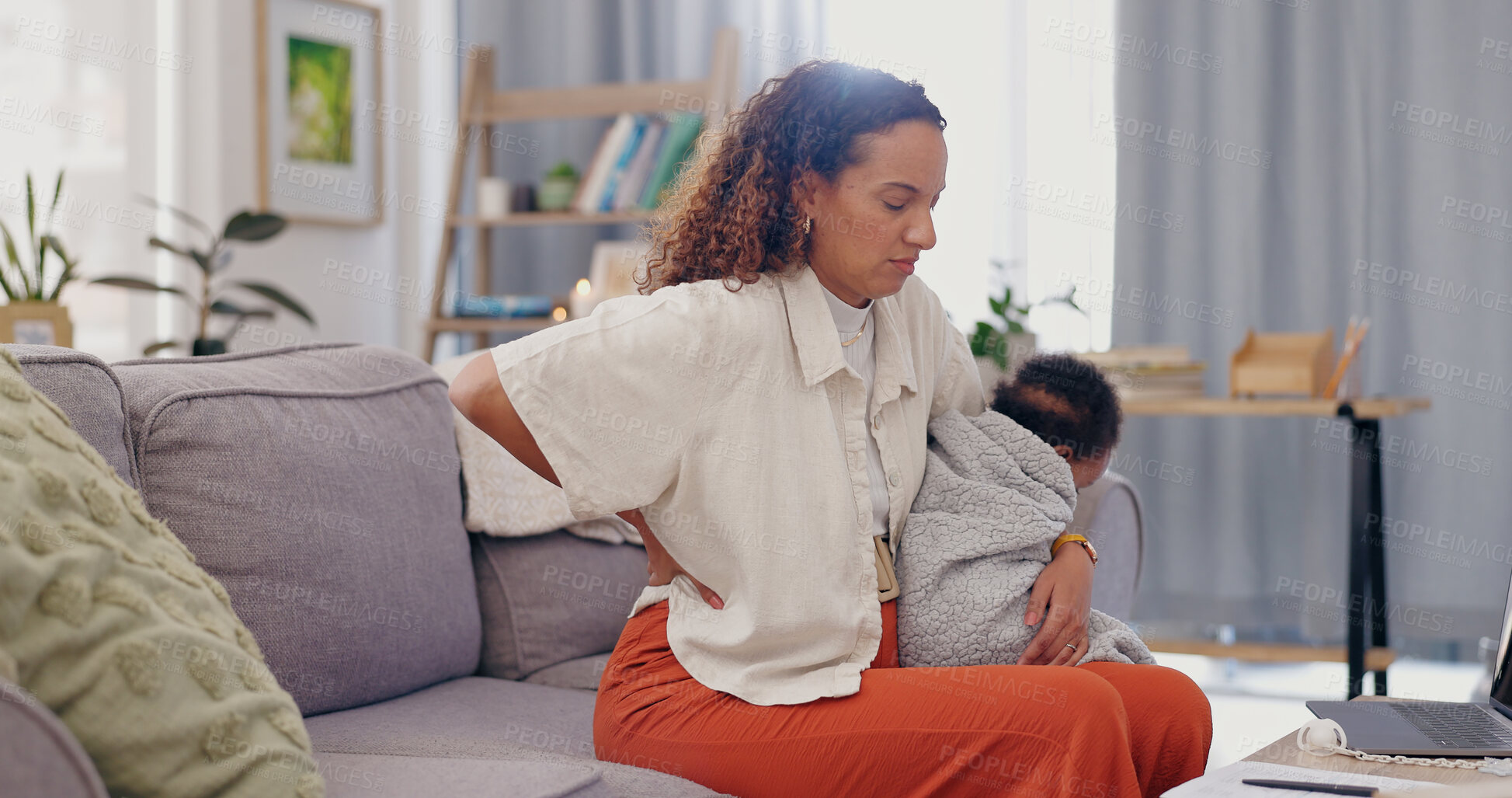 Buy stock photo Mother, baby and backache on sofa in pain, discomfort or inflammation with sore joint or spine at home. Mom with injury or holding little child, kid or newborn toddler with bad posture in living room