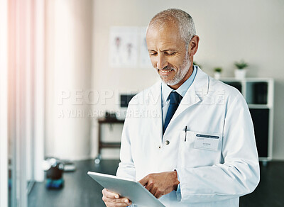Buy stock photo Mature man, doctor and tablet for research on covid in hospital, working in healthcare or medicine. Male person, ebook and reading news with smile in medical clinic, happiness for test results