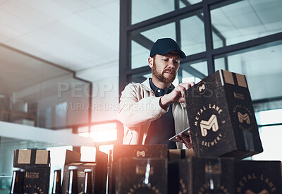 Buy stock photo Shot of a cheerful young man packing boxes on top of each other inside of a office building during the day