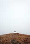 Christian cross, sky and religious symbol on hill or landscape for praying, ritual and spiritual worship. Backgrounds, believe and crucifix in nature for religion, sacrifice and christianity or faith