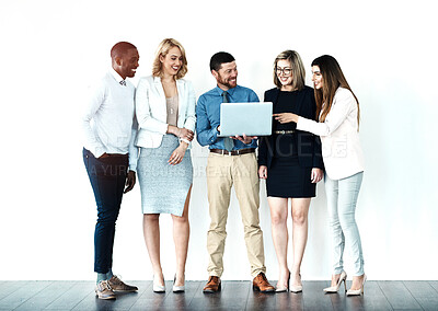 Buy stock photo Shot of a group of work colleagues standing in a line while using their wireless devices against a white background