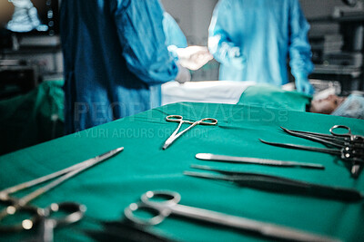 Surgery, medical and equipment on table in hospital for transplant procedure treatment. Healthcare, scissors and blur of surgeons working with metal surgical tools for healthcare operation at clinic.