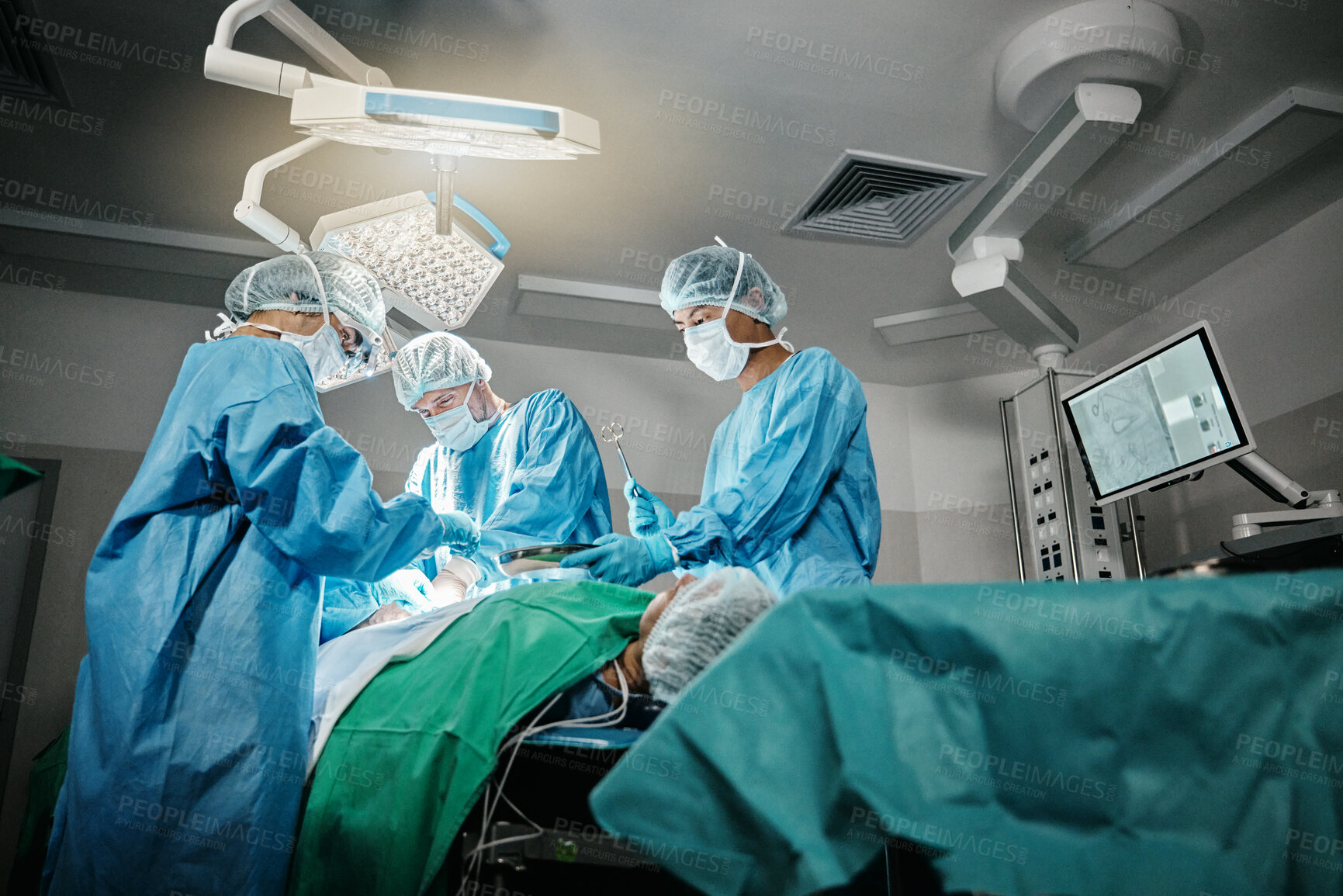 Buy stock photo Healthcare, surgery and doctors with patient for emergency medical procedure in theater. Hospital, lights and surgical team for operation on person together in ICU, professional support and help.