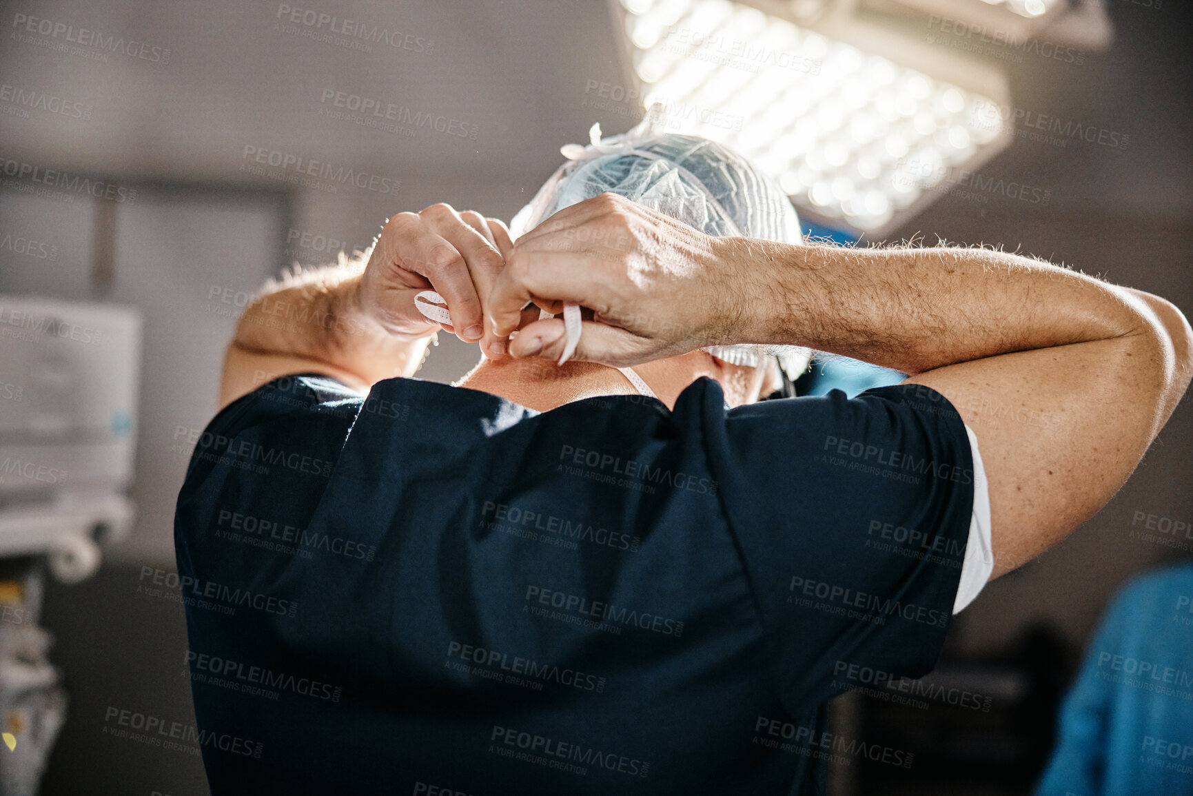 Buy stock photo Healthcare, cap and doctor in theatre for safety, cardiovascular surgery and protection in hospital. Emergency, surgeon and man with getting ready for operation, preparation or medical procedure