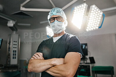 Healthcare, portrait and arms crossed by man doctor in operating room with confidence in medical, surgery or emergency. Hospital, face mask and male surgeon in theatre with pride, help or leadership