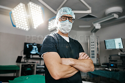 Portrait, healthcare and arms crossed by man doctor in operating room with confidence in medical, surgery or emergency. Hospital, face mask and male surgeon in theatre with pride, help or leadership