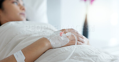 Woman hand, bed and drip in closeup, clinic and thinking with hydration, liquid or supplement. Person, healthcare and wake up with blood transfusion, anesthesia or pharma drugs for pain in hospital
