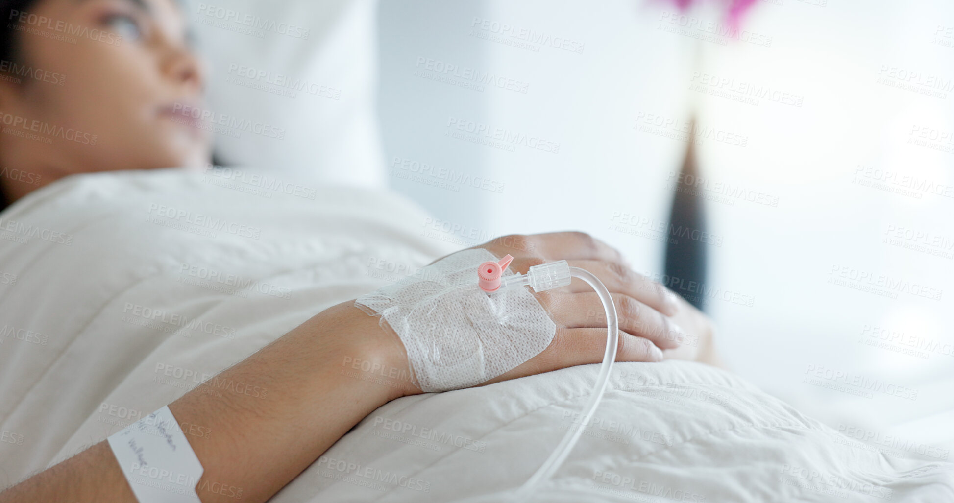 Buy stock photo Woman hand, bed and drip in closeup, clinic and thinking with hydration, liquid or supplement. Person, healthcare and wake up with blood transfusion, anesthesia or pharma drugs for pain in hospital