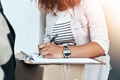 Buy stock photo Closeup shot of an unrecognizable woman signing for her delivery from the courier