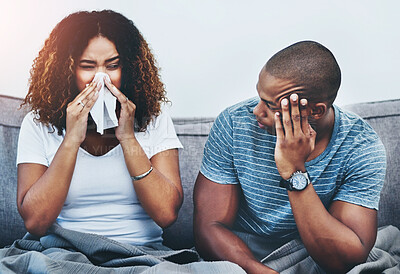 Buy stock photo Frustrated couple, sick and argument with fight on sofa in disagreement, conflict or allergies at home. Man or woman blowing nose with tissue for flu, cold or illness in breakup or toxic relationship