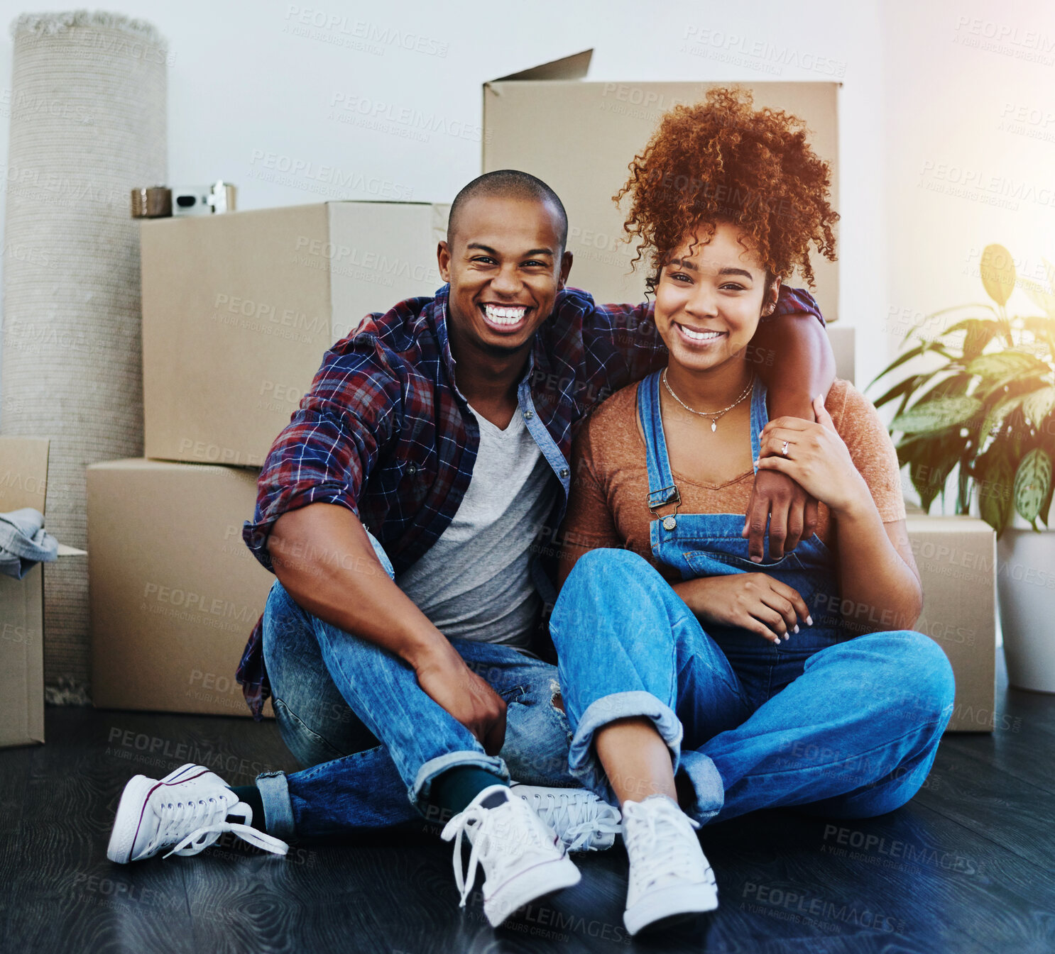 Buy stock photo Young couple, portrait and moving in new home with property, investment and excited for future together. African people relax on floor by boxes for apartment and dream house with hug, smile and love