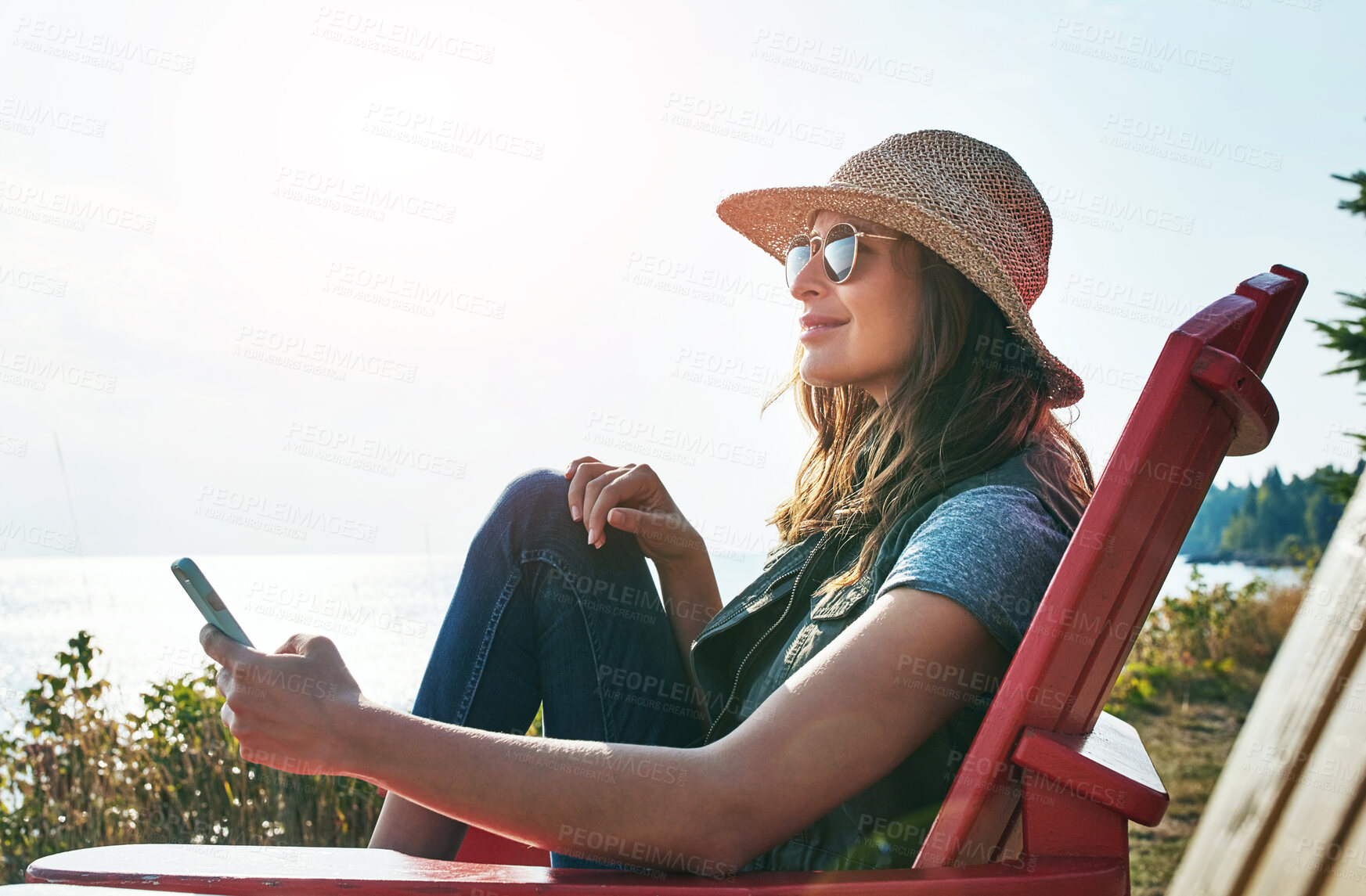 Buy stock photo Nature, relax and woman with mobile for holiday, summer vacation or happiness. Outdoor, sunglasses and female person sitting in chair for weekend trip, comfortable or peaceful morning in Michigan