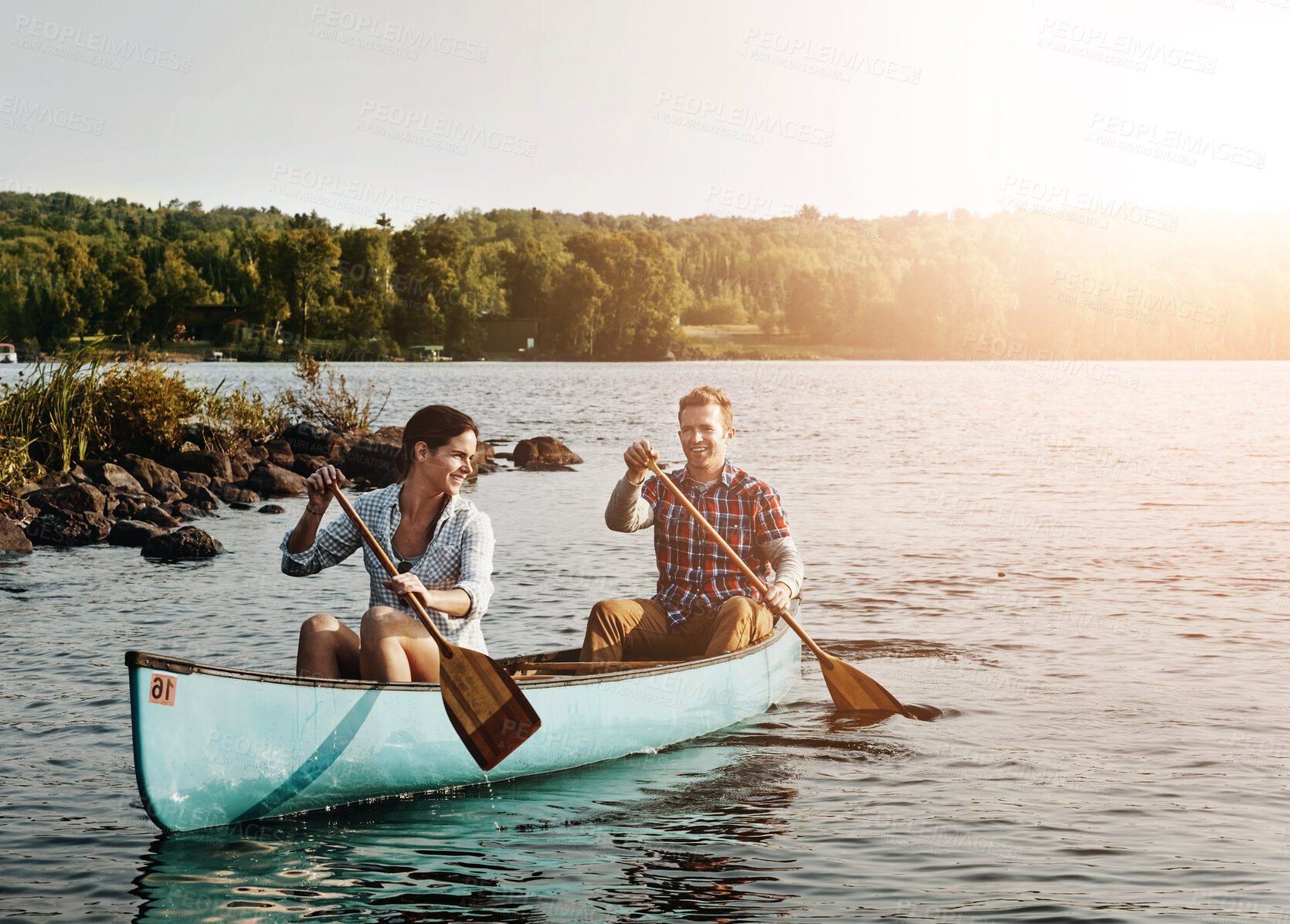 Buy stock photo Couple, kayak and rowing on lake for holiday, travel and adventure for activity on river. Paddle, water sports and vacation in Germany, sunshine and nature for married people on boat for fitness