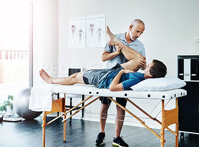 Buy stock photo Male people, knee injury and physiotherapist working in consulting room, rehabilitation with exercise for wellness. Men, office or together for physiotherapy service with health insurance and stretch