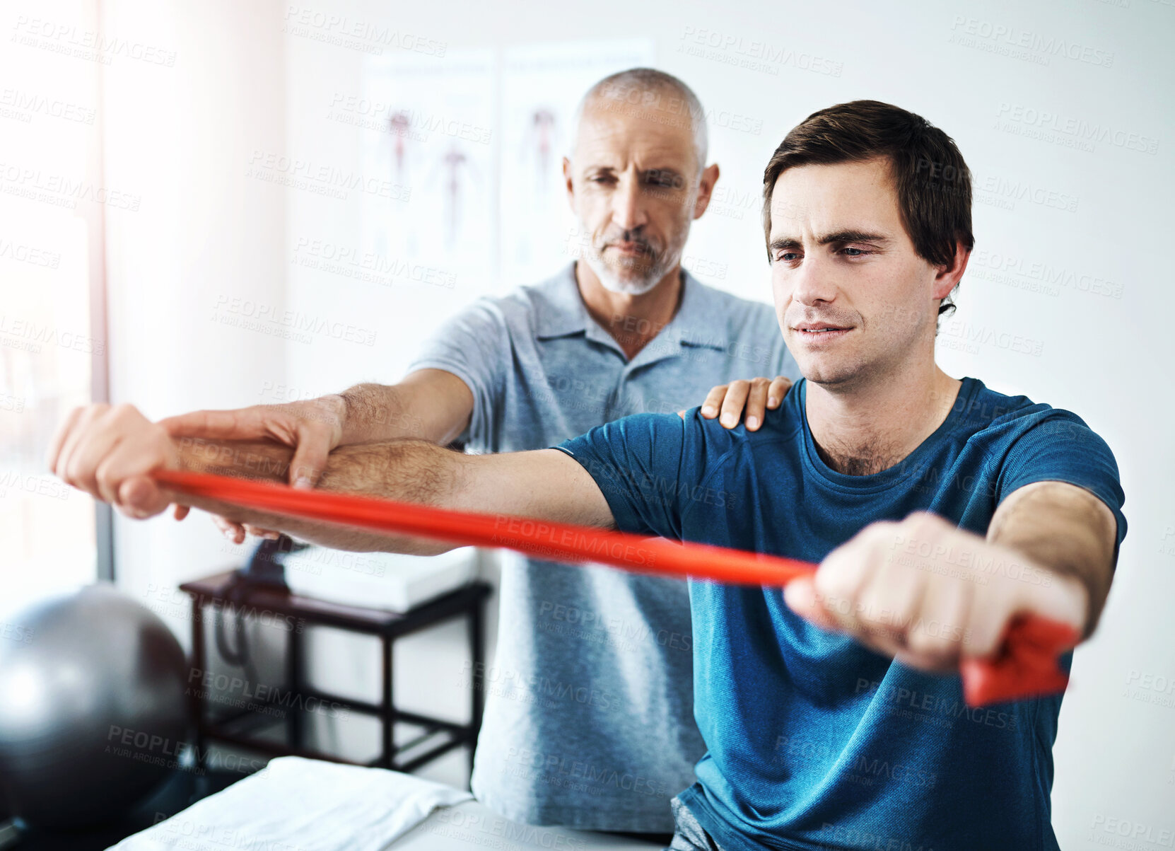 Buy stock photo Men, physiotherapist and patient for rehabilitation with resistance band for support, trust and healthcare. People, injury and clinic with fitness, exercise and training for wellness and wellbeing