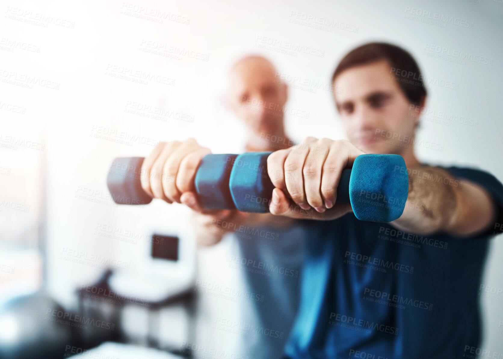 Buy stock photo Man, physiotherapy and dumbbell in hands for exercise, physiotherapist and clinic for sport injury recovery. Body wellness, mobility support and client or muscle strength, medical help and assessment