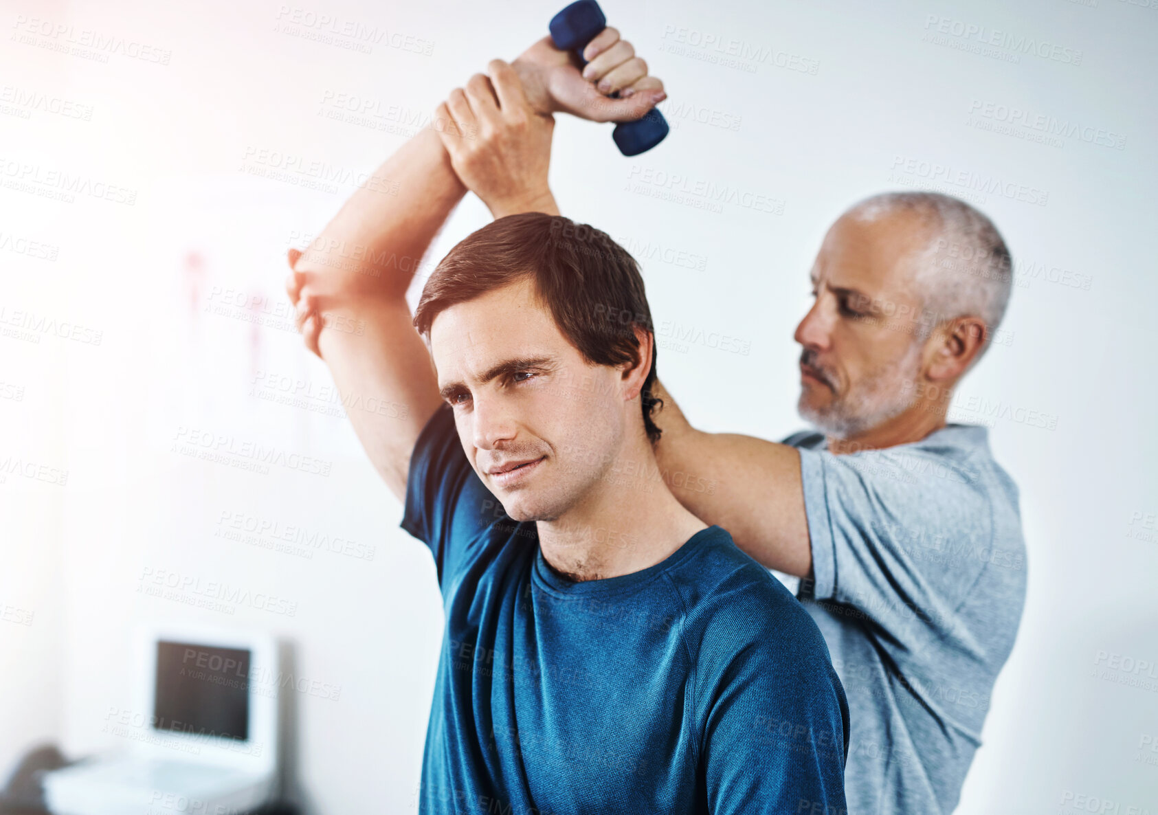 Buy stock photo Man, physiotherapy and dumbbell for arm or healthcare, physiotherapist and clinic for sport injury recovery. Body wellness, mobility support and client or muscle strength, medical help and assessment