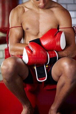 Buy stock photo Getting ready, fitness and a man with gloves for boxing, gym training and exercise for a match. Club, health and a boxer, fighter or athlete with equipment for sports, martial arts or cardio fight