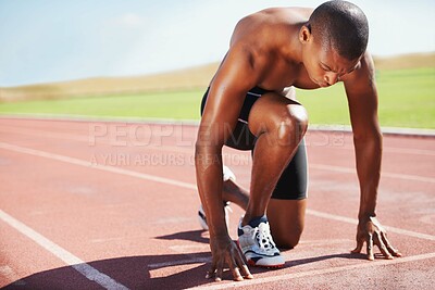Buy stock photo Man, athlete and ready for run on track with practice, training or workout for race. Black person, determination and concentration on face for go, speed and fast for athletics, sport and performance