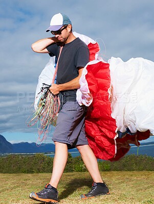 Buy stock photo Equipment, parachute or man in nature for sport, smile or strings for exercise for health support. Person, walk or preparation in outdoor fitness for wellness, fearless or safety gear in countryside