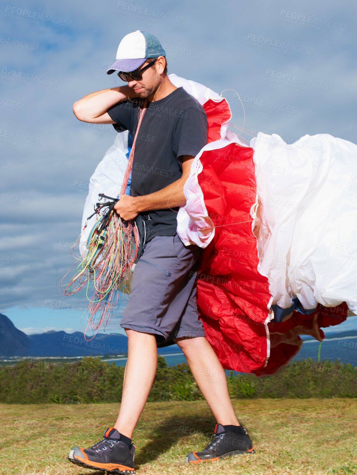 Buy stock photo Equipment, parachute or man in nature for sport, smile or strings for exercise for health support. Person, walk or preparation in outdoor fitness for wellness, fearless or safety gear in countryside