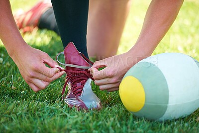 Buy stock photo Rugby, ball and sports with shoes of person on field for training, practice and challenge. Health, start and games with closeup of athlete tying laces on outdoor pitch for stadium and fitness