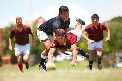 Buy stock photo Full length shot of a young rugby player scoring a try mid tackle