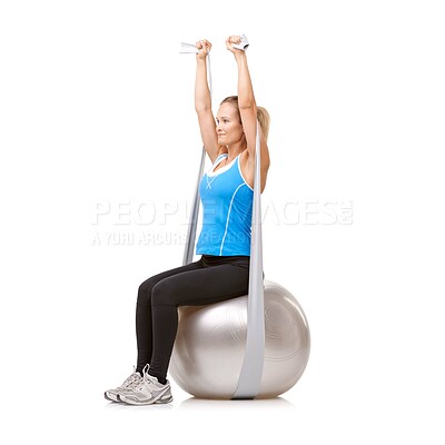 Buy stock photo Yoga ball, resistance band and woman doing exercise in studio for health, wellness and body care. Sports, fitness and young female person from Canada with arms workout or training by white background