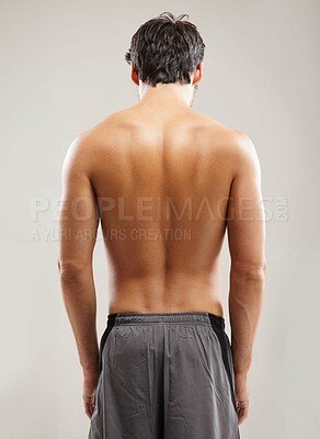 Buy stock photo Back, shirtless or athlete for fitness results, wellness and health isolated on grey background in studio. Muscle, sports man or model with progress in exercise, workout or training on backdrop alone